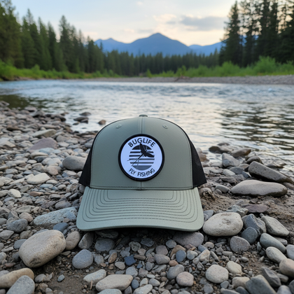 Green hat on Montana riverbank - version 1