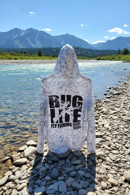 Grundens sun hoodie back upright on Montana riverbank