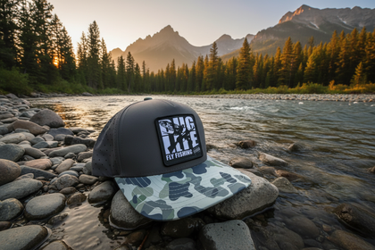 Single Gray Camo Bug Life Hat - 3/4 View on Montana Riverbank