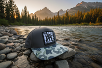 Single Gray Camo Bug Life Hat - 3/4 View on Montana Riverbank